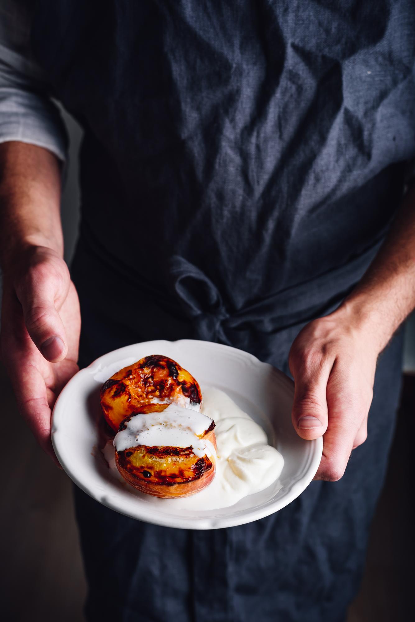 Chef preparing plated seasonal dish in warm studio